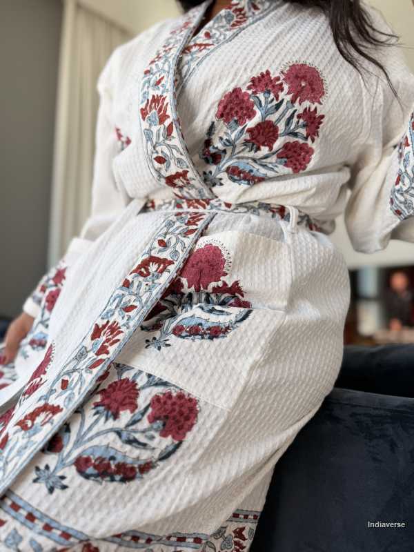Close-up of a person wearing a floral-patterned robe with a blurred background