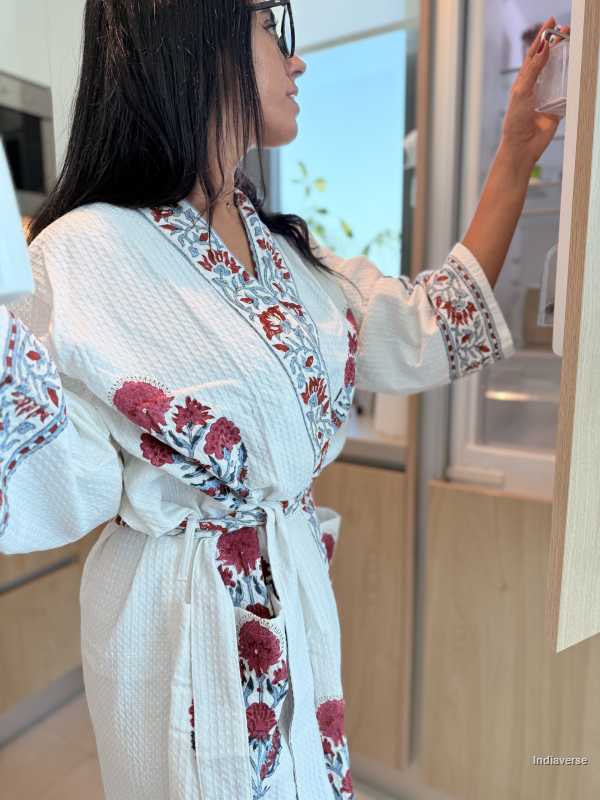 Woman wearing a floral patterned robe in a bathroom setting