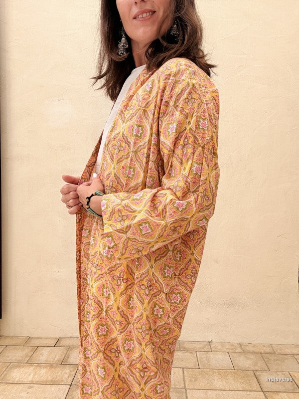 Woman wearing a patterned dress with a plain background