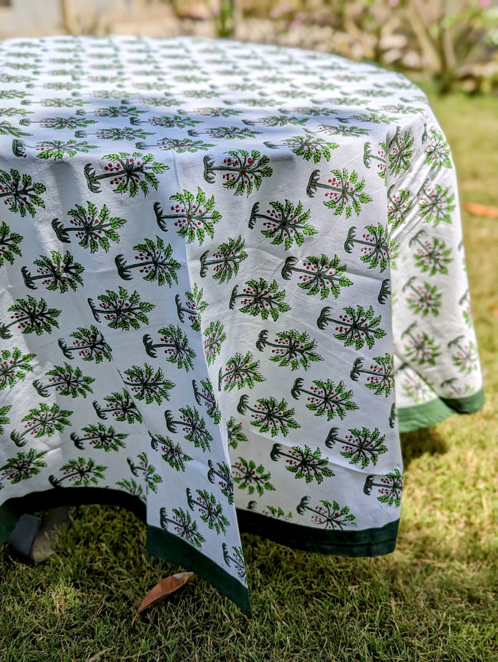 round-table-cloth-with-small-palm-tree-print-on-white-background-and-with-dark-green-border