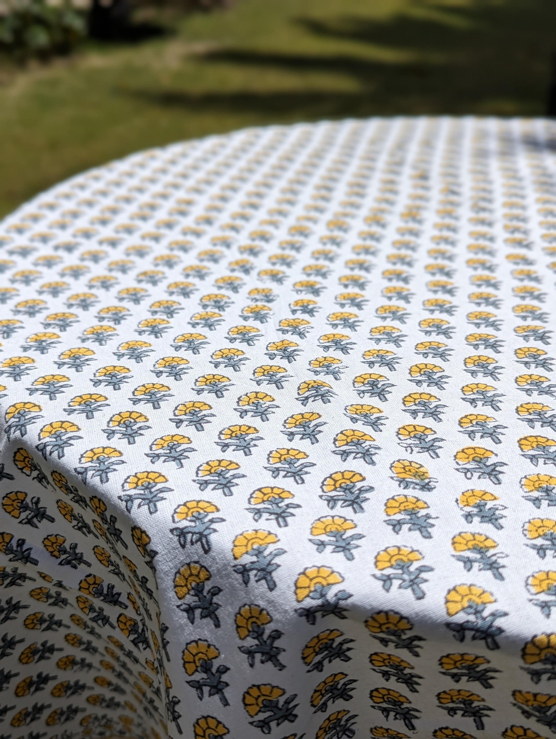 round-table-cloth-with-tiny-yellow-flowers-handblock-printed-on-white-background-with-yellow-border