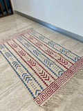 small cotton rug hand block printed with geometrical red and blue pattern perfect for the kitchen, living room or bedroom