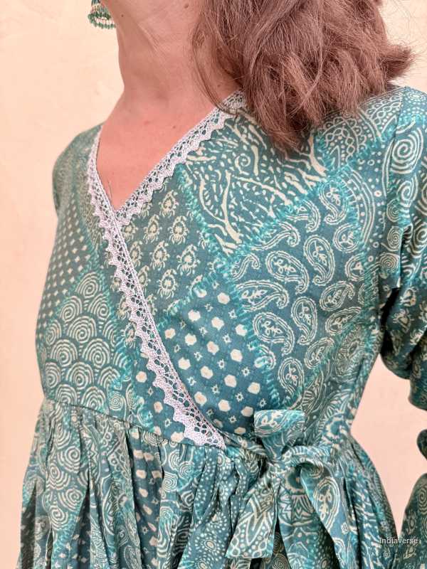 Green patterned dress with lace details on a beige background