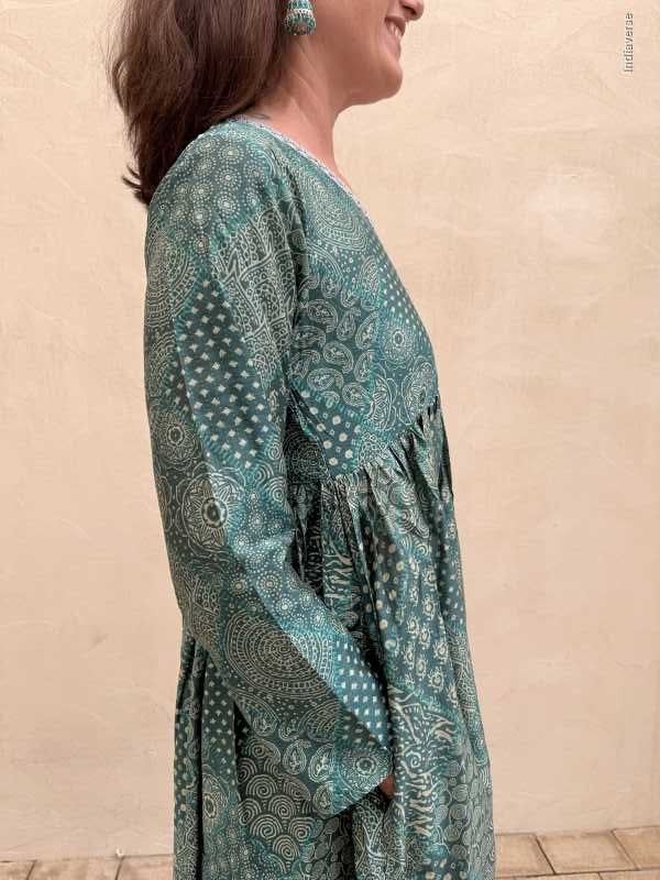 Woman wearing a hand block printed dress with a beige background