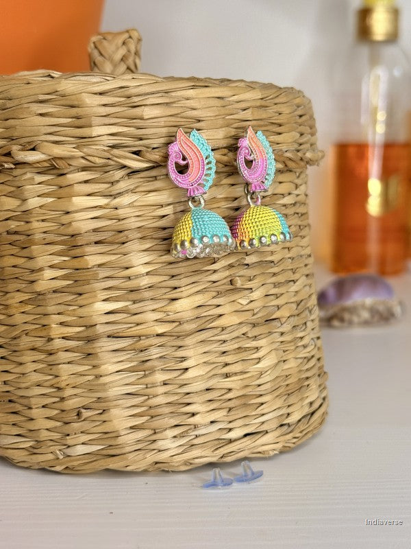Colorful earrings on a woven basket with a blurred background