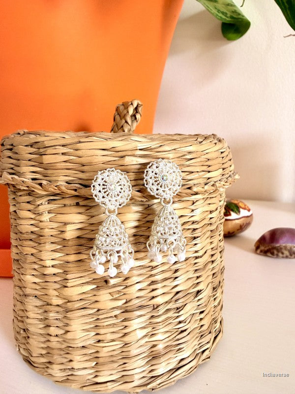 white silver small earrings with little pearls hanging from a woven basket