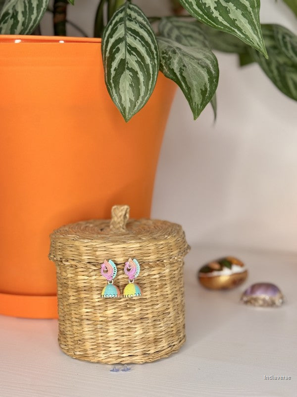 colorful small earrings hanging on a wicker basket