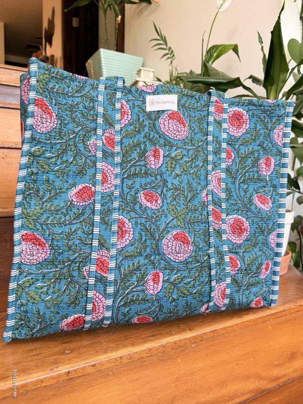 quilted cotton tote bag with floral design sitting on a wooden surface