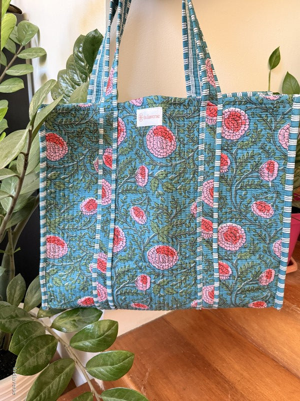 Floral-patterned bag with a strap on a plant background