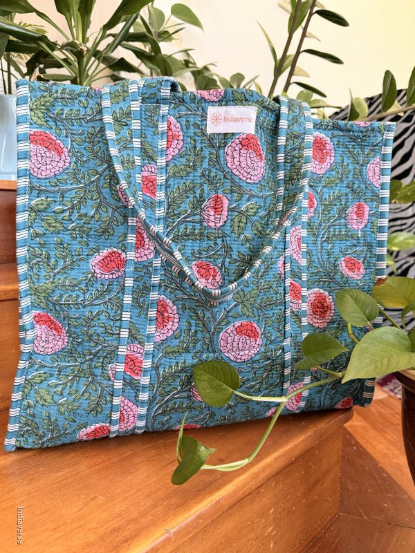 quilted cotton tote bag with pink poppy design sitting on a wooden surface
