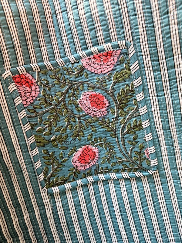 Embroidered floral design on a striped fabric background