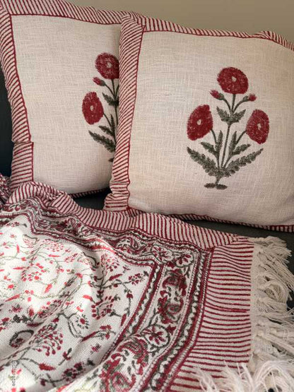 large cushions with flower pattern with matching throw blanket on couch