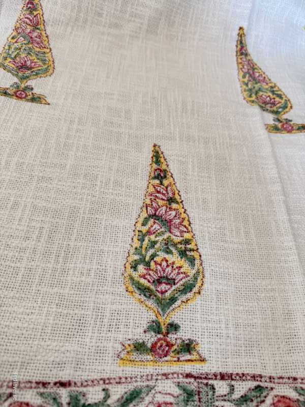 Close-up of embroidered fabric with floral patterns on a beige background