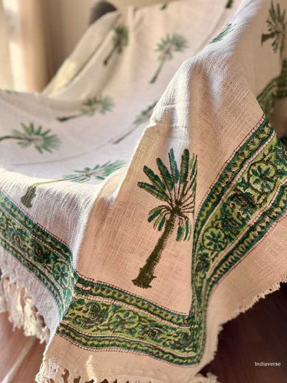 Textile with palm tree design and green patterns on a beige background