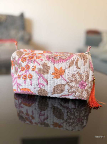 Floral-patterned pouch with tassel on a reflective surface | Paradise