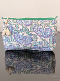 blue floral toiletry pouch sitting on a glass surface