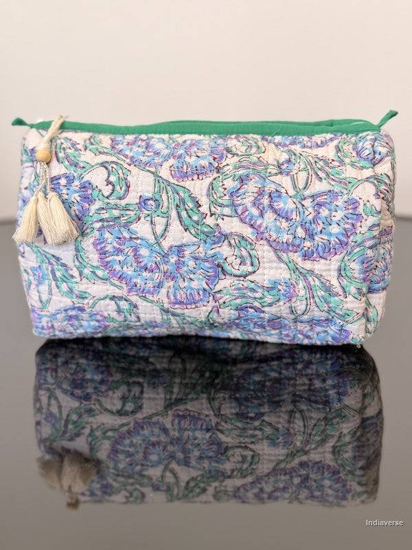 blue floral toiletry pouch sitting on a glass surface