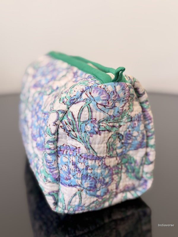 Floral patterned drawstring bag on a dark surface with a light background