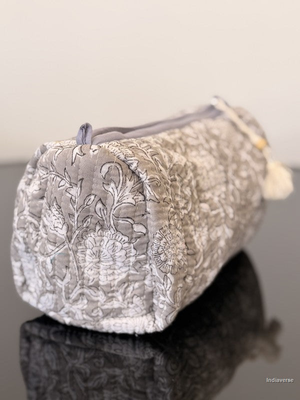 Decorative pouch with floral pattern on a reflective surface