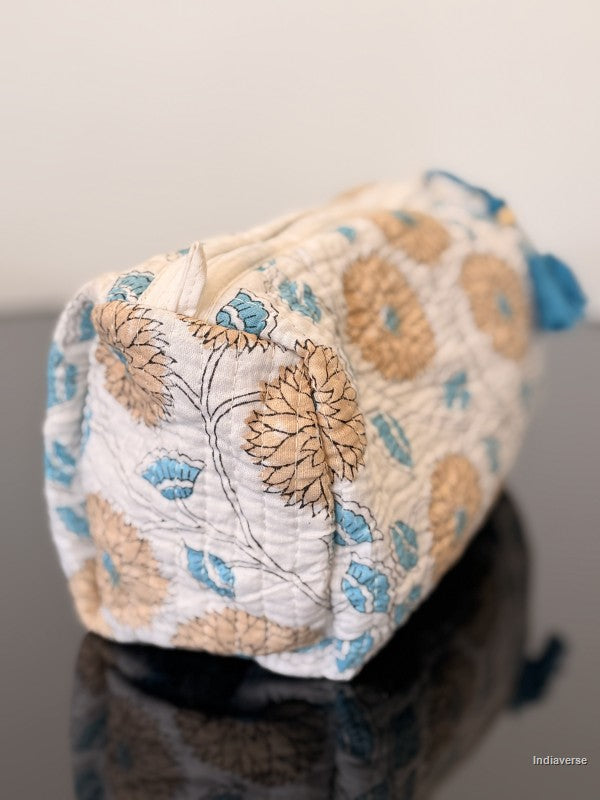 orange flower toiletry bag sitting on a glass surface