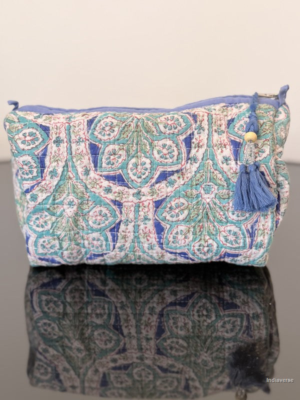 blue floral toiletry bag sitting on a glass surface