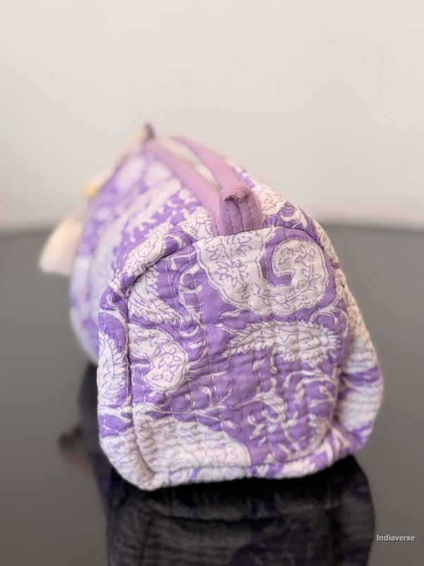 purple toiletry pouch sitting on a glass surface