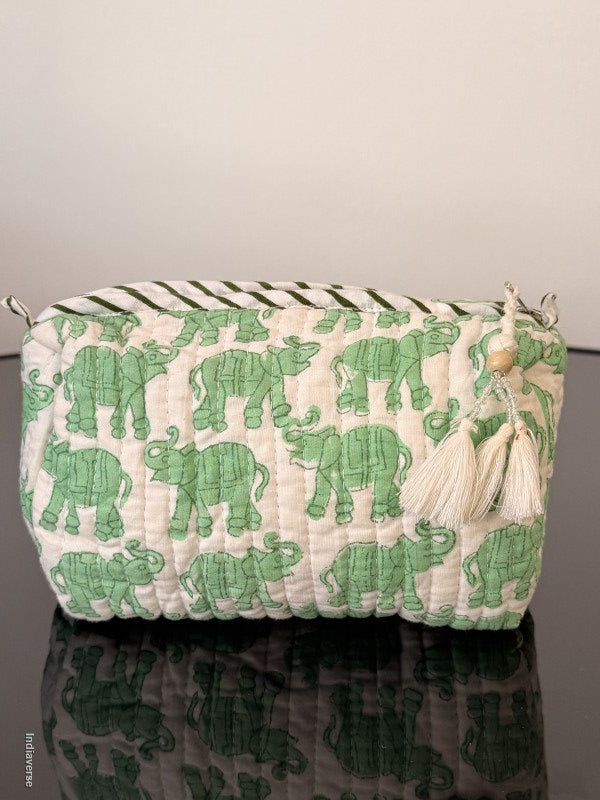 Green elephant-patterned pouch with tassels on a neutral background