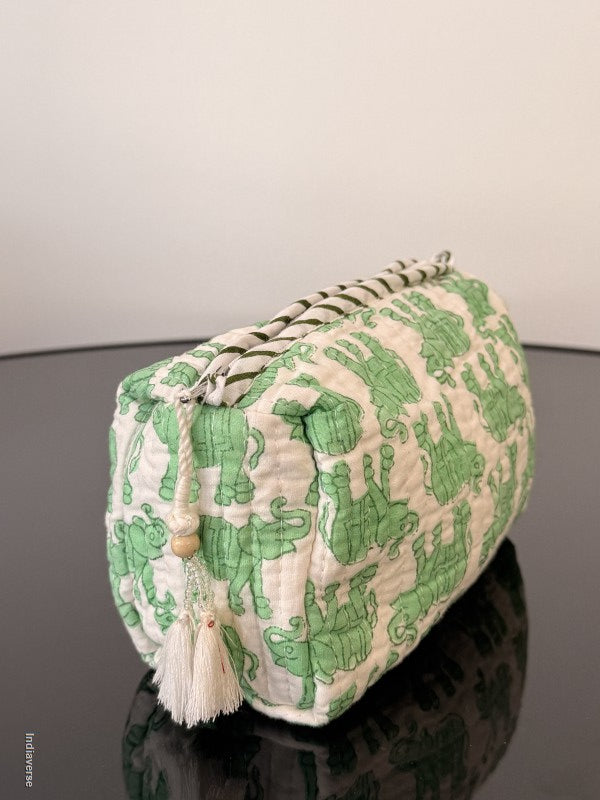 Small pouch with green frog pattern on a plain background