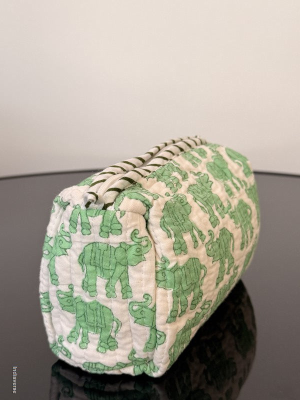 Roll of paper towels with green frog pattern on a gray background