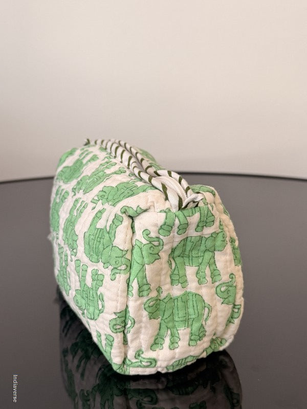 Green and white patterned fabric roll on a gray background