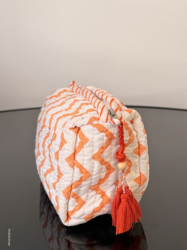 Drawstring bag with orange and white zigzag pattern on a gray background