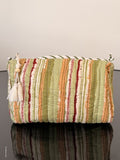 Colorful striped fabric bag on a gray background