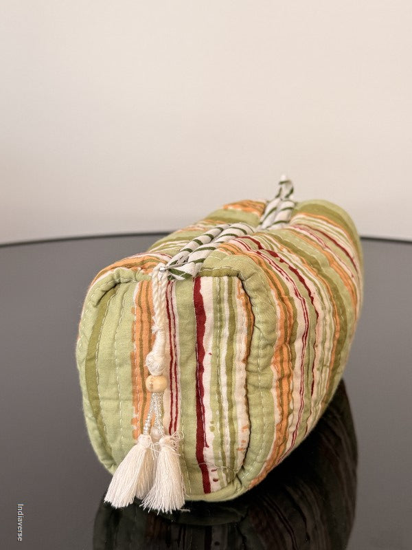 Rolled-up fabric with colorful stripes on a plain background