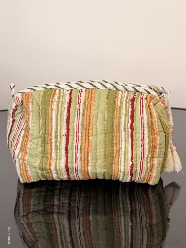 Stack of colorful striped pillows against a neutral wall