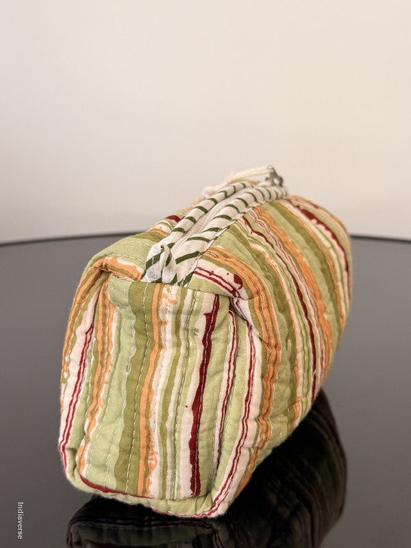 Folded striped fabric on a hanger against a neutral background