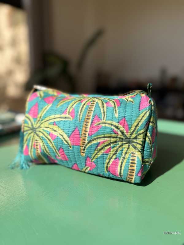Fabric pouch with tropical leaf pattern on a green surface | Tropical Bliss