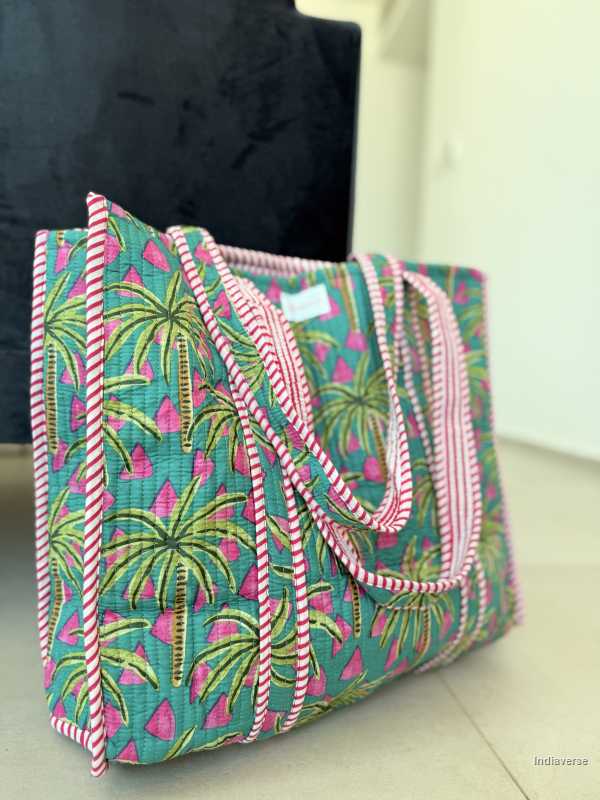 Tropical patterned bag with pink accents on a neutral background