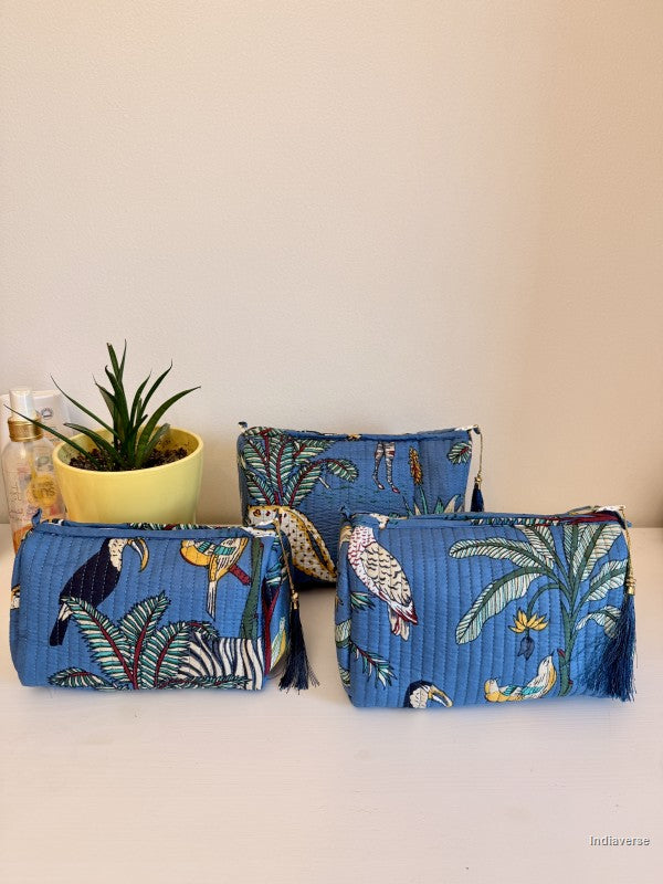 Two blue pouches with tropical bird and leaf patterns on a light surface | Tropical Jungle
