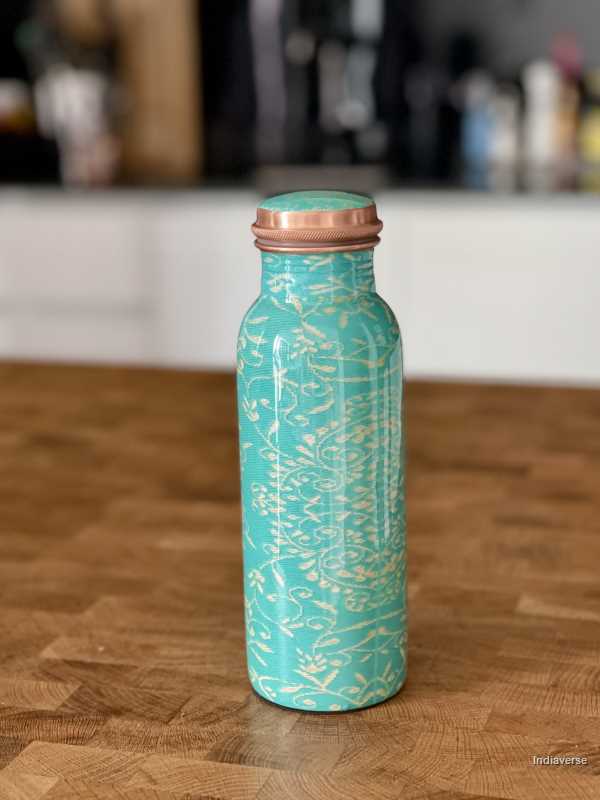 Turquoise color enameled copper bottle with ethnic design for storing drinking water with a capacity up to 600 ml