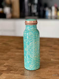 Turquoise color enameled copper bottle with ethnic design for storing drinking water with a capacity up to 600 ml