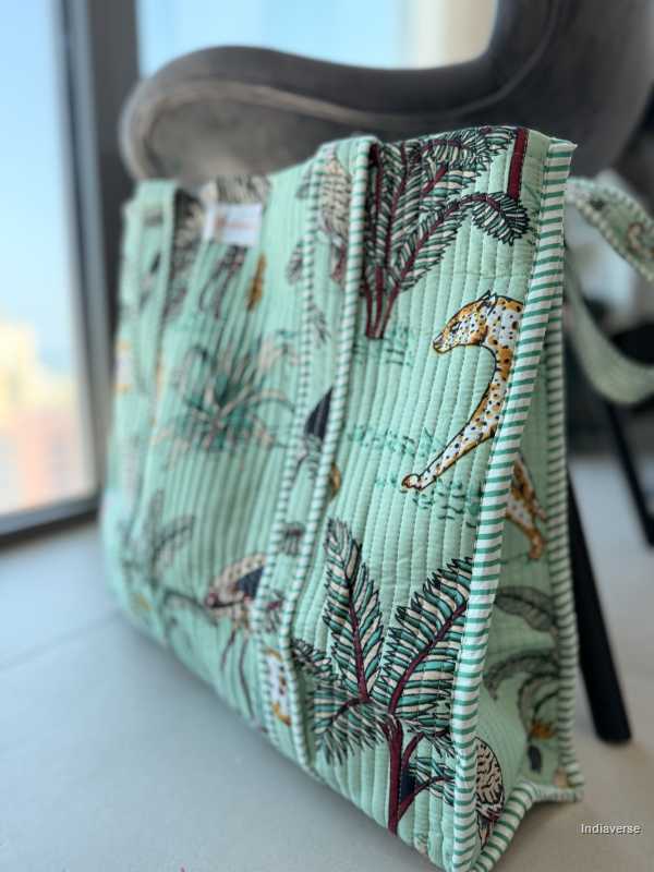 Handbag with a nature-themed design on a light surface