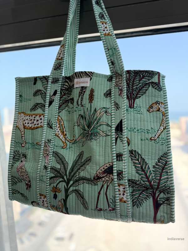 Tote bag with animal and plant pattern on a light blue background