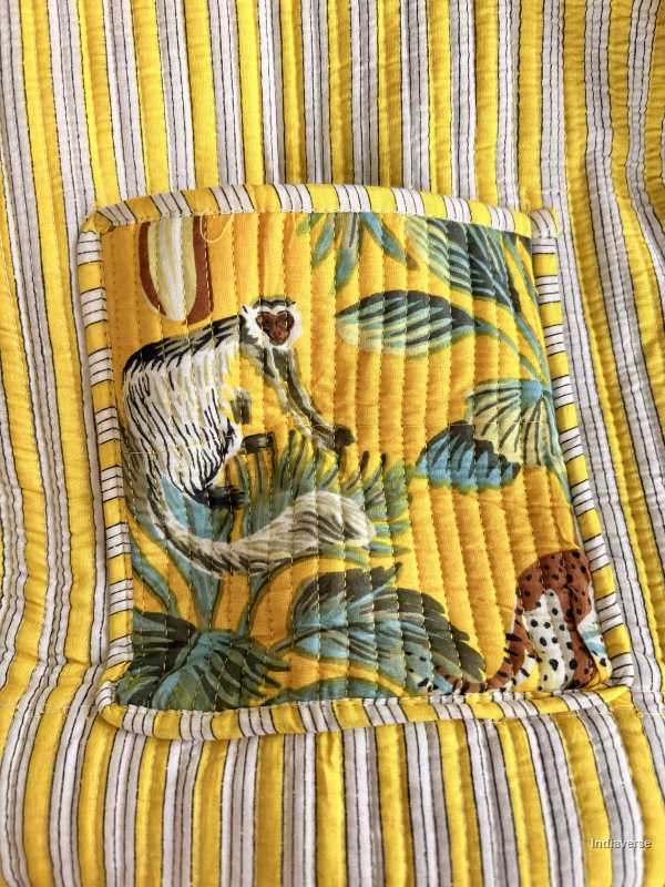 Inside pocket with jungle-themed design featuring animals and leaves on a yellow and gray striped background.