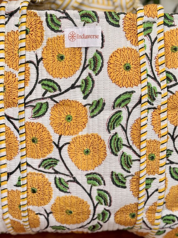close up of label on the front of the tote bag with yellow flowers