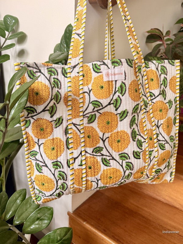 tote bag with yellow flowers hanging from a wooden beam